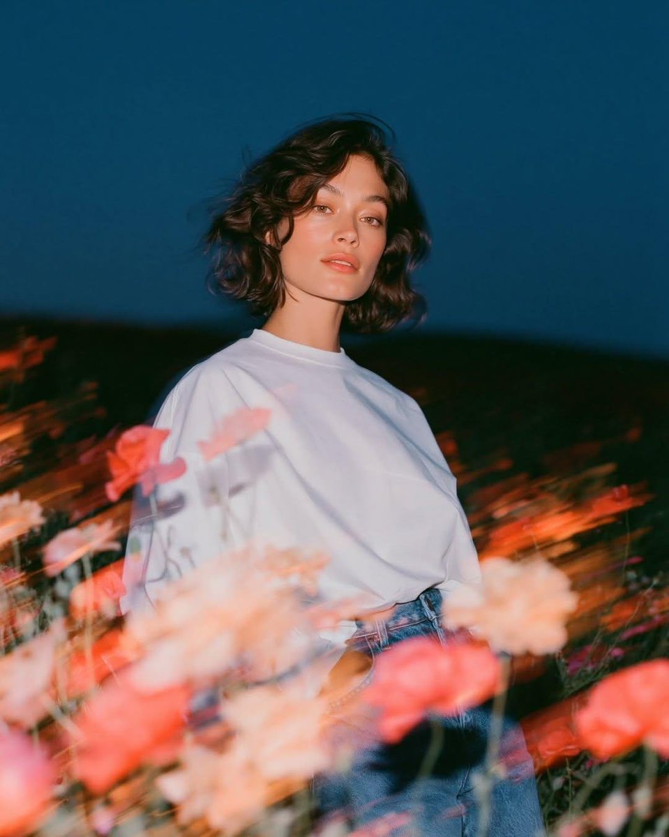 Create a cinematic fashion editorial portrait at blue hou...