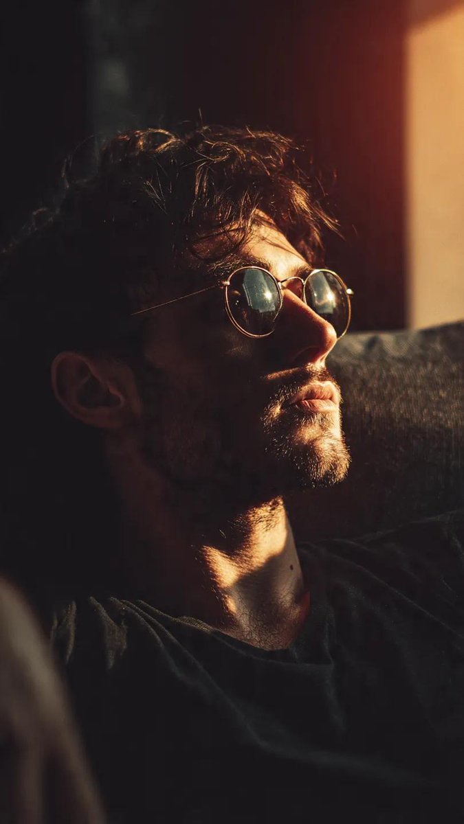 Contemplative Man in Reflective Sunglasses