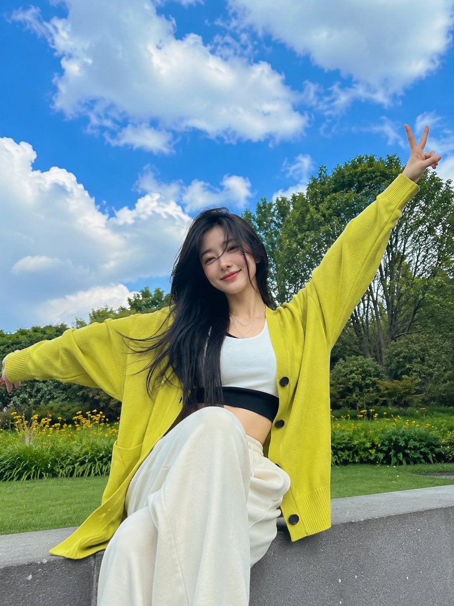 Joyful Young Woman in Neon Cardigan at Spring Park - alternate