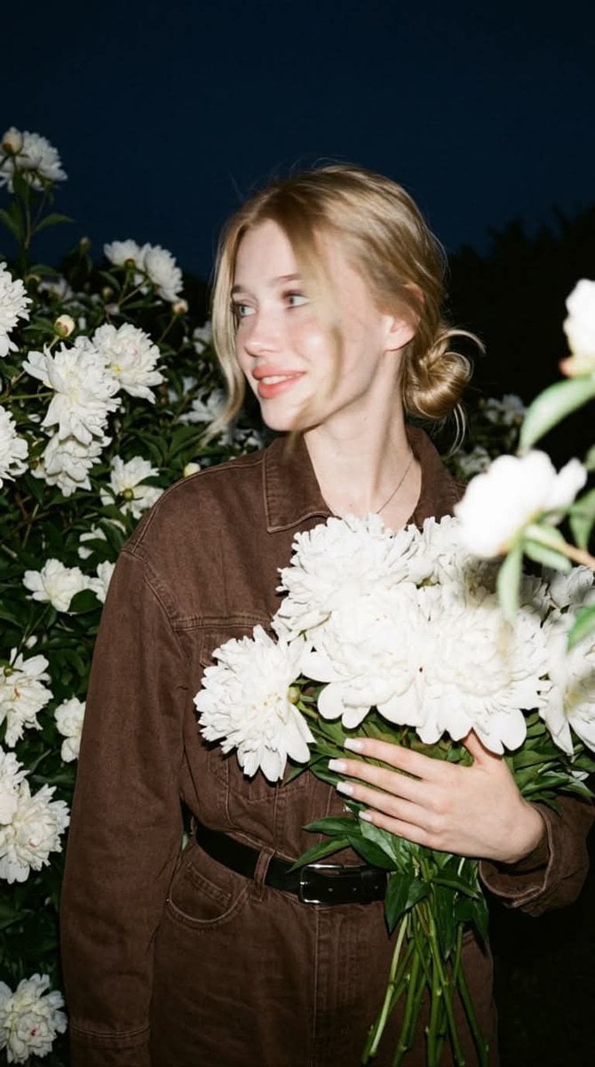 A candid nighttime editorial portrait of a young blonde w... - alternate